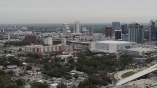 DX0003_234_019 - GLITCH 5.7K aerial stock footage of an apartment complex, Amway Center and city skyline, Downtown Orlando, Florida