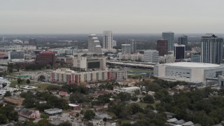 DX0003_234_020 - 5.7K aerial stock footage of apartment complex, Amway Center and city skyline, Downtown Orlando, Florida