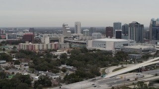 DX0003_234_023 - 5.7K aerial stock footage slowly passing apartment complex, Amway Center and city skyline, Downtown Orlando, Florida