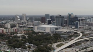 DX0003_234_027 - 5.7K aerial stock footage flying past Amway Center and city skyline, Downtown Orlando, Florida
