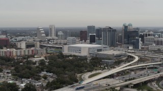 DX0003_234_028 - 5.7K aerial stock footage stationary and slowly flying by Amway Center and city skyline, Downtown Orlando, Florida