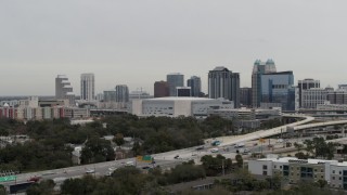 DX0003_234_031 - 5.7K aerial stock footage fly away from Amway Center arena and city skyline, Downtown Orlando, Florida