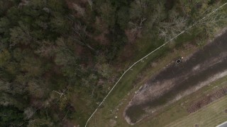 DX0003_234_049 - 5.7K aerial stock footage descend toward clearing on edge of forest, Orlando, Florida