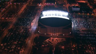 ED0001_000007 - HD stock footage aerial video approach and tilt to United Center at night, Downtown Chicago skyline in the background, Illinois