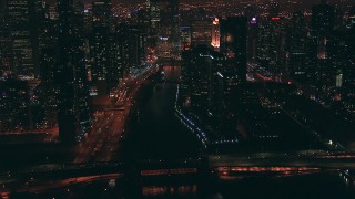 ED0001_000079 - HD stock footage aerial video follow the Chicago River toward Trump Tower skyscraper at night in Downtown Chicago, Illinois
