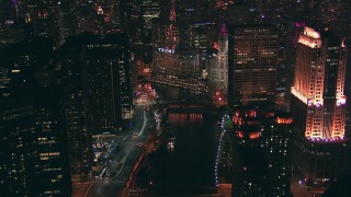 ED0001_000080 - HD stock footage aerial video fly over the Chicago River bridges toward Trump Tower skyscraper sign at night, Downtown Chicago, Illinois