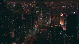 ED01_109 - HD stock footage aerial video follow the Chicago River toward Trump Tower skyscraper at night, Downtown Chicago, Illinois