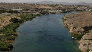 FG0001_000009 - 4K aerial stock footage follow the Colorado River past a small riverfront hotel in Bullhead City, Arizona