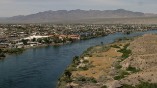 FG0001_000011 - 4K aerial stock footage pan across riverfront homes and apartments on the Colorado River in Bullhead City, Arizona
