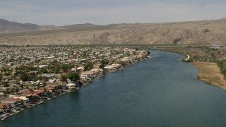 FG0001_000014 - 4K aerial stock footage of waterfront homes with docks beside the Colorado River in Bullhead City, Arizona