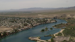 FG0001_000019 - 4K aerial stock footage of houses and docks beside a bend in the Colorado River in Bullhead City, Arizona