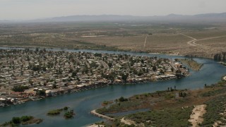 FG0001_000020 - 4K aerial stock footage of residential neighborhood beside the Colorado River in Bullhead City, Arizona