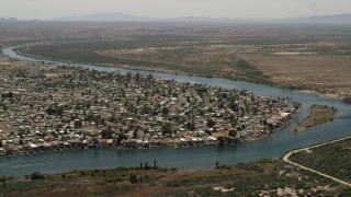 FG0001_000021 - 4K aerial stock footage of waterfront residential neighborhood on the Colorado River in Bullhead City, Arizona