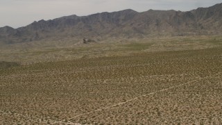 FG0001_000024 - 4K aerial stock footage of Dead Mountains Wilderness Area seen from flat Mojave Desert plain in Laughlin, Nevada