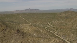 FG0001_000030 - 4K aerial stock footage of hills and open Mojave Desert on the border of Nevada and California