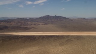 FG0001_000059 - 4K stock footage aerial video of a dry lake near Mojave Desert mountains in San Bernardino County, California