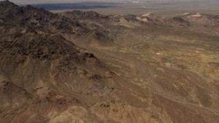 FG0001_000078 - 4K aerial stock footage tilt from Mojave Desert mountains to reveal Pisgah Crater in San Bernardino County, California