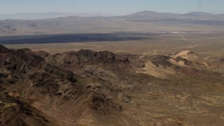 FG0001_000080 - 4K stock footage aerial video fly over rugged Mojave Desert mountains to approach Pisgah Crater in San Bernardino County, California