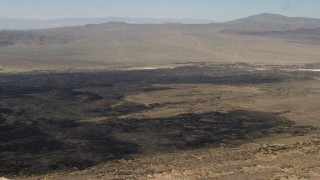 FG0001_000086 - 4K aerial stock footage pan across Pisgah Crater and lava field in Mojave Desert, San Bernardino County, California
