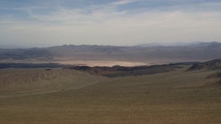 FG0001_000095 - 4K stock footage aerial video of a dry lake and distant mountains in the Mojave Desert, San Bernardino County, California