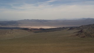 FG0001_000096 - 4K aerial stock footage of a distant dry lake and mountains in the Mojave Desert, San Bernardino County, California
