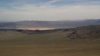 FG0001_000097 - 4K aerial stock footage of a dry lake and mountains in the Mojave Desert, San Bernardino County, California