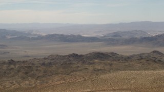 FG0001_000109 - 4K aerial stock footage of passing Iron Ridge mountains and small ranges in the Mojave Desert, San Bernardino County, California