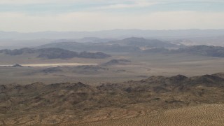 FG0001_000110 - 4K aerial stock footage of Iron Ridge mountains and small ridges in the background in the Mojave Desert, San Bernardino County, California