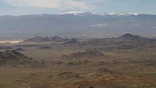 FG0001_000113 - 4K aerial stock footage of the San Bernardino Mountains behind Mojave Desert mountains, San Bernardino County, California