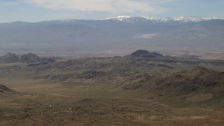 FG0001_000117 - 4K aerial stock footage of the snowy San Bernardino Mountains and Mojave Desert mountains, San Bernardino County, California