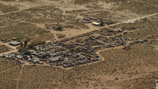 FG0001_000121 - 4K aerial stock footage of an auto junkyard in the Mojave Desert, San Bernardino County, California