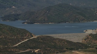 FG0001_000127 - 4K aerial stock footage approach the dam as speedboats cruise across Silverwood Lake, California