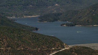 FG0001_000129 - 4K aerial stock footage approach Silverwood Lake as watercraft race across the water, California