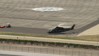 FG0001_000151 - 4K aerial stock footage of a civilian helicopter on the ground at Whiteman Airport, Pacoima, California