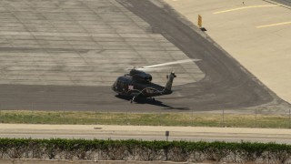 FG0001_000152 - 4K aerial stock footage of a civilian helicopter at Whiteman Airport, Pacoima, California