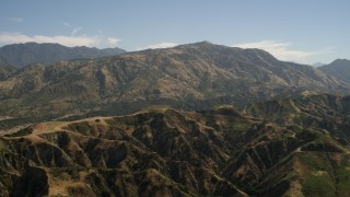 FG0001_000155 - 4K aerial stock footage of a mountain ridge and tall peak in the San Gabriel Mountains, California