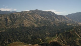FG0001_000156 - 4K aerial stock footage pan across a mountain peak in the San Gabriel Mountains, California