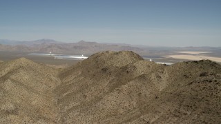 FG0001_000169 - 4K aerial stock footage of desert mountains and the Ivanpah Solar Electric Generating System in California