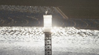 FG0001_000201 - 4K aerial stock footage of a view of a boiler atop a power tower at the Ivanpah Solar Electric Generating System in California
