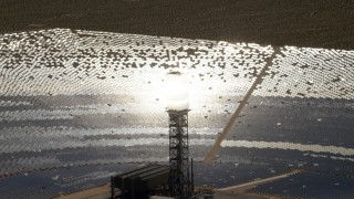 FG0001_000206 - 4K aerial stock footage of glowing power tower boiler and mirrors at the Ivanpah Solar Electric Generating System in California