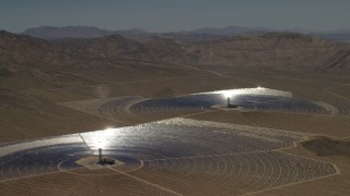 FG0001_000222 - 4K aerial stock footage of a pair of mirror arrays and power towers at the Ivanpah Solar Electric Generating System in California