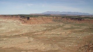 FG0001_000228 - 4K aerial stock footage of a mesa across a desert plain in the Arizona Desert