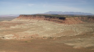 FG0001_000229 - 4K aerial stock footage of a mesa seen across a desert plain in the Arizona Desert
