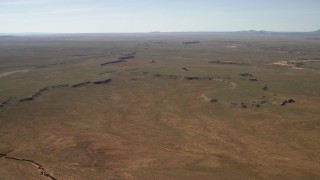 FG0001_000231 - 4K aerial stock footage of passing a wide desert plain in the Arizona Desert