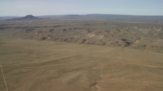 FG0001_000232 - 4K aerial stock footage of low mesas on a wide desert plain in the Arizona Desert