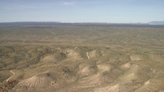 FG0001_000237 - 4K aerial stock footage tilt from a bird's eye view of mesas to reveal a wide plain in the Arizona Desert