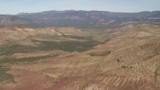 FG0001_000241 - 4K aerial stock footage of passing a valley between mountains in the Arizona Desert