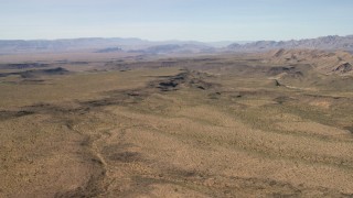 FG0001_000247 - 4K aerial stock footage of canyons cutting through the desert plain in the Arizona Desert