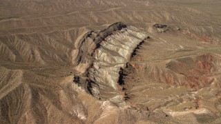 FG0001_000265 - 4K aerial stock footage approach a scarred hillside in the Nevada Desert
