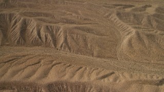 FG0001_000268 - 4K aerial stock footage tilt from a bird's eye view of hills in the Nevada Desert to reveal the wider landscape and Lake Mead